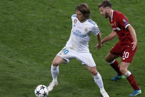 Liverpool's Adam Lallana, right, duels for the ball with Real Madrid's Luka Modric during the Champions League Final soccer match between Real Madrid and Liverpool at the Olimpiyskiy Stadium in Kiev, Ukraine, Saturday, May 26, 2018. (AP Photo/Darko Vojinovic)