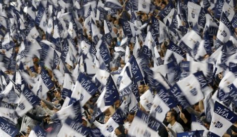 Tottenham fans wave flags during the English Premier League soccer match between Tottenham Hotspur and Manchester United at White Hart Lane stadium in London, Sunday, May 14, 2017. (AP Photo/Frank Augstein)