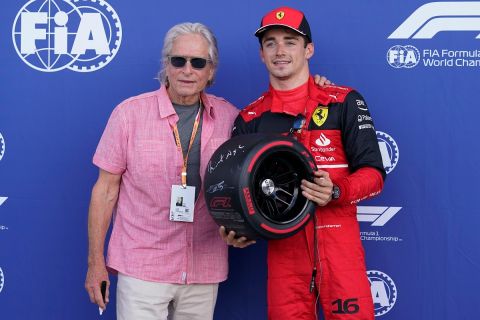 Ferrari driver Charles Leclerc of Monaco poses with actor Michael Douglas after winning pole position during qualifying for the Formula One Miami Grand Prix auto race at the Miami International Autodrome, Saturday, May 7, 2022, in Miami Gardens, Fla. (AP Photo/Darron Cummings)