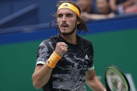 Stefanos Tsitsipas of Greece reacts as he plays against Novak Djokovic of Serbia during the men's singles quarterfinals match at the Shanghai Masters tennis tournament at Qizhong Forest Sports City Tennis Center in Shanghai, China, Friday, Oct. 11, 2019. (AP Photo/Andy Wong)