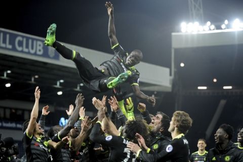 Chelsea's players throw Chelsea's N'Golo Kante in the air to celebrate after the English Premier League soccer match between West Bromwich Albion and Chelsea, at the Hawthorns in West Bromwich, England, Friday, May 12, 2017. Chelsea won the match 0-1 meaning they win the Premier League title. (AP Photo/Rui Vieira)