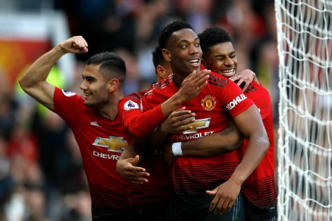 Manchester United's Anthony Martial, centre, celebrates scoring his side's second goal of the game with teammates, during the English Premier League soccer match between Manchester United and Watford, at Old Trafford, in Manchester, England, Saturday March 30, 2019. (Martin Rickett/PA via AP)