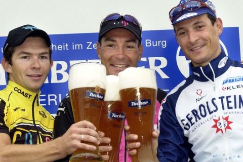 The winner of the cycling race across Nuremberg Erik Zabel of Team Telekom, center, runner-up Olaf Pollack of team Gerolsteiner, right, and third placed Steffen Radochla of team Coast clink glasses with Bavarian beer as they stand on the podium, Sunday Sept. 1, 2002 in Nuremberg, southern Germany. Some 120 cyclists took part in the 194 kilometers race around the old town of Nuremberg.  (AP Photo/Frank Boxler)