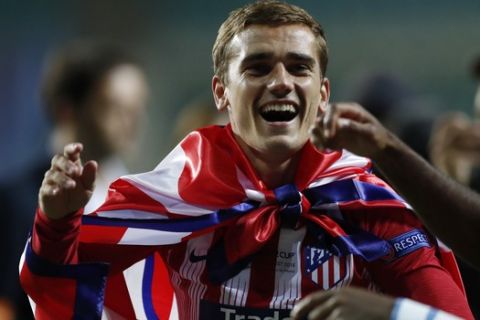 Atletico's Antoine Griezmann celebrates after winning the UEFA Super Cup final soccer match between Real Madrid and Atletico Madrid at the Lillekula Stadium in Tallinn, Estonia, Wednesday, Aug. 15, 2018. (AP Photo/Pavel Golovkin)