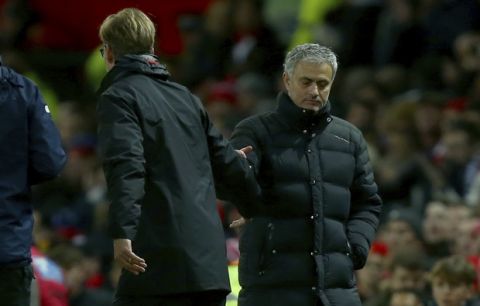 Manchester United's manager Jose Mourinho, right, and Liverpool's head coach Juergen Klopp shake hands at the end of the English Premier League soccer match between Manchester United and Liverpool at Old Trafford stadium in Manchester, England, Sunday, Jan. 15, 2017. (AP Photo/Dave Thompson)
