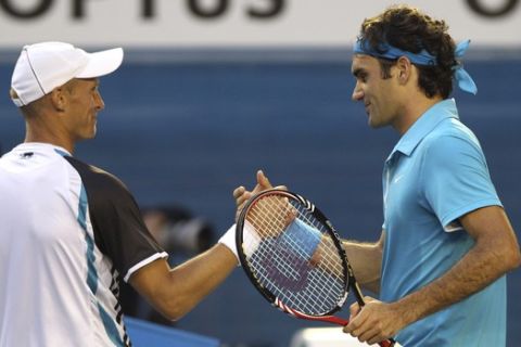 Roger Federer of Switzerland, right,  and Nikolay Davydenko of Russia shake hands at the net after Federer  won their Men's singles quarterfinal match at the Australian Open tennis championship in Melbourne, Australia, Wednesday Jan. 27, 2010.  (AP Photo/Rick Rycroft)