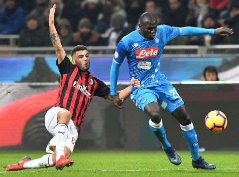 Milan's Lucas Paquet' left, and Napoli's Fabian Ruiz in action during their Italian Serie A soccer match between AC Milan and Napoli, at the Giuseppe Meazza stadium in Milan, Italy, Saturday, Jan. 26, 2019. (Daniel Dal Zennaro/ANSA via AP)