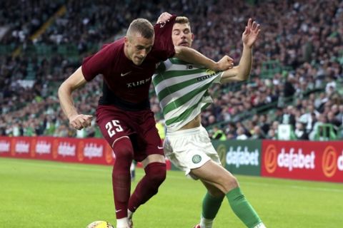 FK Sarajevo's Besim Serbecic, left, and Celtic's Ryan Christie battle for the ball during the Champions League first qualifying round, second leg soccer match at Celtic Park, Glasgow, Scotland, Wednesday July 17, 2019. (Andrew Milligan/PA via AP)
