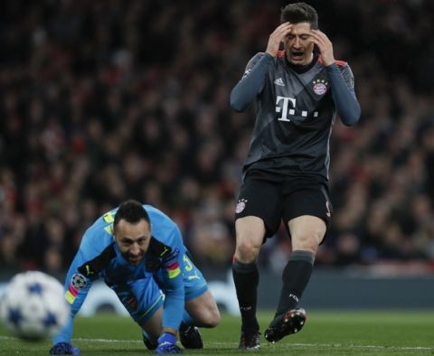 Bayern's Robert Lewandowski gestures after missing a scoring chance, during the Champions League round of 16 second leg soccer match between Arsenal and Bayern Munich at the Emirates Stadium in London, Tuesday, March 7, 2017. At left is Arsenal goalkeeper David Ospina. (AP Photo/Kirsty Wigglesworth)