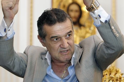 FILE -  A file picture taken on June 9, 2009 showing Gigi Becali, the owner of Steaua football club, and a former shepherd, gesturing during an interview with the Associated Press in Bucharest. Romania's top court has sentenced the owner of Steaua football club, the former chief of staff of the armed forces and a former defense minister to two years in prison each for abusing their positions and bribery in a real estate deal.The court sentenced Gigi Becali, Steaua's owner and also a former MEP, on Monday for abetting public officials to abuse their position in a real estate swap with the Army between 1996 and-1999. (AP Photo/Vadim Ghirda, File)