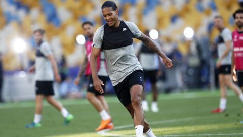 Liverpool's Virgil van Dijk runs with the ball during a training session at the Olimpiyskiy Stadium in Kiev, Ukraine, Friday, May 25, 2018 ahead of the Champions League final soccer match between Real Madrid and Liverpool on Saturday May 26. (AP Photo/Pavel Golovkin)