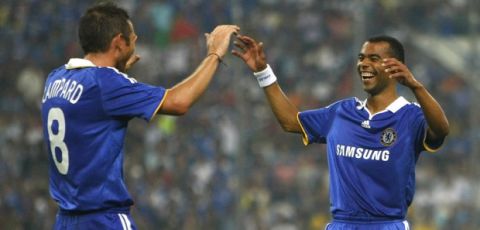 Chelsea  goalscorer  Ashley Cole, right, celbrates with  Frank Lampard after Lampard assisted in the goal  during the match against Malaysia team  at Shah Alam stadium, near Kuala Lumpur, Malaysia, Tuesday, July 29, 2008. Chelsee won the match with score 2-0.(AP Photo/Vincent Thian)