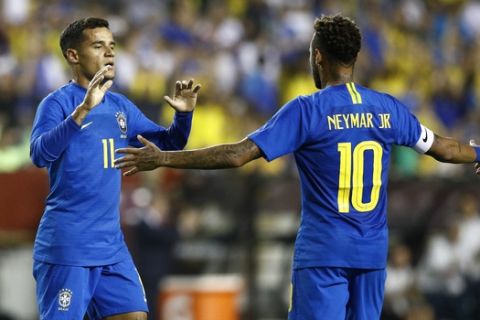 Brazil forward Philippe Coutinho, left, celebrates his goal with teammate Neymar in the first half of a soccer match against El Salvador, Tuesday, Sept. 11, 2018, in Landover, Md. (AP Photo/Patrick Semansky)