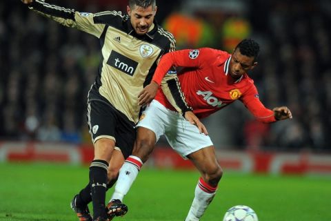Benfica's Javi Garcia (L) tackles Manchester United's Portuguese midfielder Nani (R) during the UEFA Champions League, Group C, football match between Manchester United and Benfica at Old Trafford in Manchester, north-west England, on November 22, 2011. AFP PHOTO/ANDREW YATES (Photo credit should read ANDREW YATES/AFP/Getty Images)