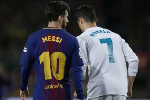 Barcelona's Lionel Messi, left and Real Madrid's Cristiano Ronaldo walk back to take positions during a Spanish La Liga soccer match between Barcelona and Real Madrid, dubbed 'el clasico', at the Camp Nou stadium in Barcelona, Spain, Sunday, May 6, 2018. (AP Photo/Manu Fernandez)