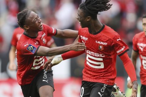 Rennes' Eduardo Camavinga, right, celebrates with his teammate Brandon Soppy after scoring his side's second goal during the League One soccer match between Rennes and Montpellier, at the Roazhon Park stadium in Rennes, France, Saturday, Aug. 29, 2020. (AP Photo/David Vincent)