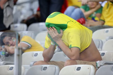 BELO HORIZONTE, BRAZIL - JULY 8: A Brazilian fan looks dejected after the 2014 FIFA World Cup Brazil Semi Final match between Brazil and Germany at Estadio Mineirao on July 8, 2014 in Belo Horizonte, Brazil. (Photo by Jean Catuffe/Getty Images)