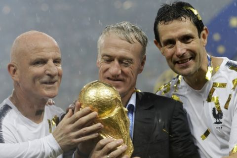 France head coach Didier Deschamps, second right, holds the trophy at the end of the final match between France and Croatia at the 2018 soccer World Cup in the Luzhniki Stadium in Moscow, Russia, Sunday, July 15, 2018. (AP Photo/Matthias Schrader)