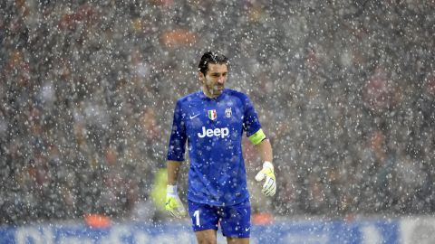 Juventus' goalkeeper Gianluigi Buffon leaves the pitch after a heavy snow fall halted the UEFA Champions League group B football match between Juventus and Galatasaray at the TT Arena Stadium in Istanbul on December 30, 2013. AFP PHOTO/BULENT KILIC        (Photo credit should read BULENT KILIC/AFP/Getty Images)
