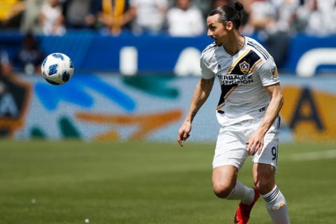 FILE - In this March 31, 2018, file photo, LA Galaxy's Zlatan Ibrahimovic, of Sweden, dribbles the ball during the second half of an MLS soccer match against Los Angeles FC in Carson, Calif. Ibrahimovic scored twice in an electrifying debut for the Galaxy last week despite jet lag and not being in top shape. A week later, the Swede plays his second MLS game, facing Sporting Kansas City on Sunday. (AP Photo/Jae C. Hong. File)