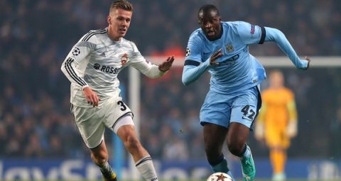 MANCHESTER, ENGLAND - NOVEMBER 05:  Yaya Toure of Manchester City competes with Pontus Wenbloom of CSKA Moscow during the UEFA Champions League Group E match between Manchester City and CSKA Moscow on November 5, 2014 in Manchester, United Kingdom.  (Photo by Alex Livesey/Getty Images)