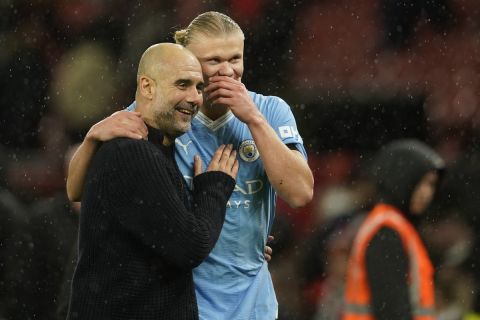 Manchester City's head coach Pep Guardiola talks to Manchester City's Erling Haaland after the English Premier League soccer match between Manchester United and Manchester City at Old Trafford stadium in Manchester, England, Sunday, Oct. 29, 2023. (AP Photo/Dave Thompson)