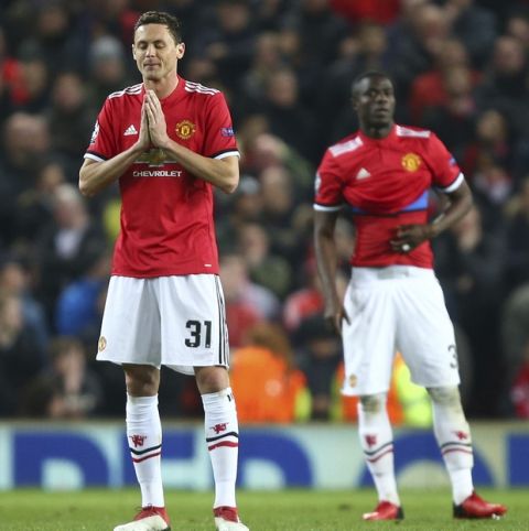 Manchester United's Nemanja Matic, left and Manchester United's Paul Pogba react as they wait for the restart after Sevilla scored their second goal of the game during the Champions League round of 16 second leg soccer match between Manchester United and Sevilla, at Old Trafford in Manchester, England, Tuesday, March 13, 2018. (AP Photo/Dave Thompson)