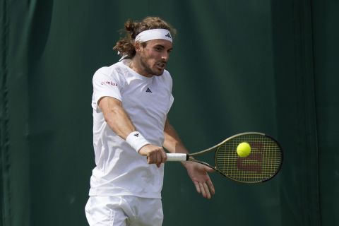 Stefanos Tsitsipas of Greece returns to Christopher Eubanks of the US in a men's singles match on day eight of the Wimbledon tennis championships in London, Monday, July 10, 2023. (AP Photo/Alastair Grant)