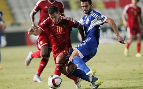 Belgium's Eden Hazard fights for the ball by Cyprus' Kostas Laifis, right,  during the Euro 2016 qualifying Group B match between Cyprus and Belgium, at GSP stadium, in Nicosia, Cyprus, Sunday, Sept. 6, 2015. Belgium beat Cyprus 1-0. (AP Photo/Petros Karadjias)