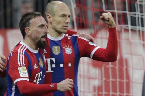 Bayern's Arjen Robben from the Netherlands, right, celebrates with teammate Franck Ribery from France after scoring his side's opening goal during the German first division Bundesliga soccer match between FC Bayern and SC Freiburg in the Allianz Arena in Munich, Germany, on Tuesday, Dec. 16, 2014. (AP Photo/Matthias Schrader)