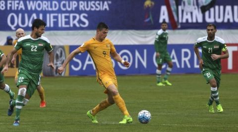 Australia's Tomi Juric, center, passes the ball as he is followed by Iraq's Rebin Ghareeb Solaka, left, and Saad Abdulameer Al-Dobjahawe, right, during their World Cup qualifying soccer match at Pas Stadium in Tehran, Iran, Thursday, March 23, 2017. The match ended 1-1.(AP Photo/Vahid Salemi)