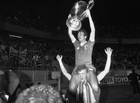 Liverpool player Alan Kennedy, who scored the only goal in the match, sits on the shoulders of team-mate Phil Neal, while holding the European Football Cup trophy, after they had defeated Real Madrid in the Final at the Parc Des Princes, Paris on May 27, 1981. Liverpool defeated Real 1-0. (AP Photo/Staff/Lipchitz)