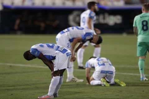 Leganes' players react after the Spanish La Liga soccer match between Leganes and Real Madrid at the Butarque Stadium in Leganes, on the outskirts of Madrid, Spain, Sunday, July 19, 2020. The match ended 2-2 draw, and Leganes being relegated from La Liga to the second division. (AP Photo/Bernat Armangue)
