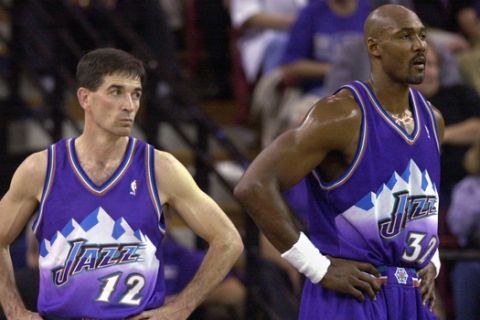 Utah Jazz's John Stockton, left, and Karl Malone watch as the Sacramento Kings walk onto the court following a time-out during the third quarter of Game 5 of the Western Conference first-round playoff series, Wednesday, April 30, 2003, in Sacramento, Calif.  The Kings won 111-91, winning the series 4-1. (AP Photo/Rich Pedroncelli)