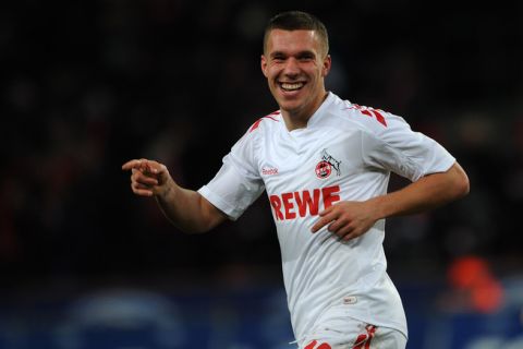 Cologne's striker Lukas Podolski celebrates during the German first division Bundesliga football match 1. FC Cologne vs 1.FSV Mainz 05 in the western German city of Cologne, on December 13, 2011.  AFP PHOTO / PATRIK STOLLARZ

RESTRICTIONS / EMBARGO - DFL LIMITS THE USE OF IMAGES ON THE INTERNET TO 15 PICTURES (NO VIDEO-LIKE SEQUENCES) DURING THE MATCH AND PROHIBITS MOBILE (MMS) USE DURING AND FOR FURTHER TWO HOURS AFTER THE MATCH. FOR MORE INFORMATION CONTACT DFL. (Photo credit should read PATRIK STOLLARZ/AFP/Getty Images)
