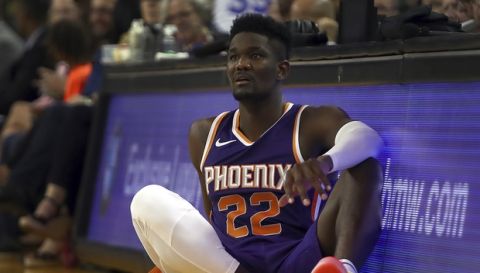 Phoenix Suns' Deandre Ayton waits on the sideline during the second half of a preseason NBA basketball game against the Golden State Warriors Monday, Oct. 8, 2018, in Oakland, Calif. (AP Photo/Ben Margot)