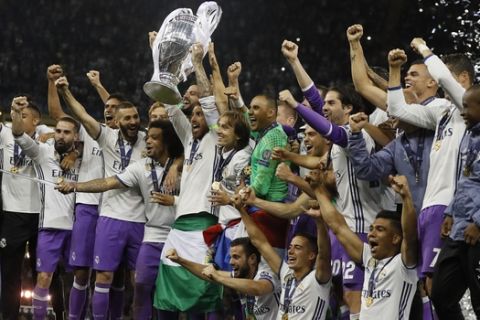 Real Madrid's Marcelo raises the trophy after the Champions League final soccer match between Juventus and Real Madrid at the Millennium stadium in Cardiff, Wales Saturday June 3, 2017. (AP Photo/Kirsty Wigglesworth)