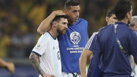 A teammate embraces Argentina's Lionel Messi after losing 0-2 to Brazil in a Copa America semifinal soccer match at the Mineirao stadium in Belo Horizonte, Brazil, Tuesday, July 2, 2019. (AP Photo/Ricardo Mazalan)