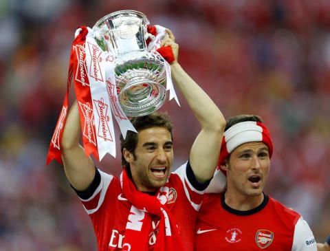 Arsenal's Mathieu Flamini, left, and Olivier Giroud, right, and  celebrates after winning the English FA Cup final soccer match between Arsenal and Hull City at Wembley Stadium in London, Saturday, May 17, 2014. Arsenal won 3-2 after extra-time. (AP Photo/Kirsty Wigglesworth) 