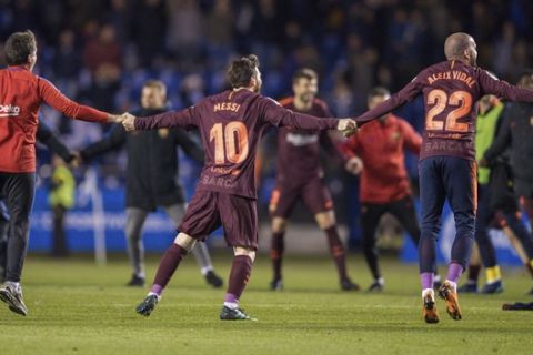 Barcelona's Lionel Messi, center, and teammates celebrate after winning the 2017-18 Spanish La Liga at the end of the soccer match between Deportivo and Barcelona at the Riazor stadium in A Coruna, Spain, Sunday, April 29, 2018. (AP Photo/Lalo R. Villar)
