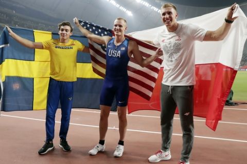 Gold medal winner Sam Kendricks, center, of the United States, poses with silver medal winner Armand Duplantis, left, of Sweden. and bronze medal winner Piotr Lisek, right, of Poland, after the the men's pole vault final at the World Athletics Championships in Doha, Qatar, Tuesday, Oct. 1, 2019. (AP Photo/Hassan Ammar)
