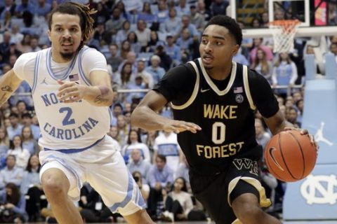 Wake Forest's Brandon Childress (0) drives against North Carolina's Cole Anthony (2) during the second half of an NCAA college basketball game in Chapel Hill, N.C., Tuesday, March 3, 2020. (AP Photo/Chris Seward)