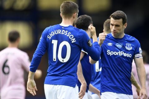 Everton's Gylfi Sigurdsson, left, reacts after scoring his side's second goal during the English Premier League soccer match between Everton and Leicester at Goodison Park in Liverpool, England, Wednesday, July 1, 2020. (Peter Powell/Pool via AP)