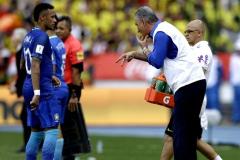 Brazil's coach Tite, right, gives instructions to Neymar, right, during a 2018 Russia World Cup qualifying soccer match against Colombia, at the Roberto Melendez stadium in Barranquilla, Colombia, Tuesday, Sept. 5, 2017. (AP Photo/Fernando Vergara)
