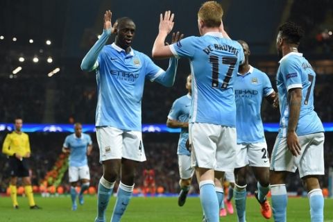 Manchester City's Belgian midfielder Kevin De Bruyne (C) celebrates with teammates after scoring during a UEFA Champions league Group D football match between Manchester City and Sevilla at the Etihad Stadium in Manchester, north west England on October 21, 2015.           AFP PHOTO / PAUL ELLIS        (Photo credit should read PAUL ELLIS/AFP/Getty Images)