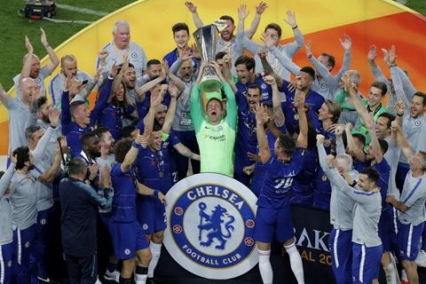 Chelsea players celebrate with the trophy after their 4-1 win in the Europa League Final soccer match between Chelsea and Arsenal at the Olympic stadium in Baku, Azerbaijan, Wednesday, May 29, 2019. (AP Photo/Dmitri Lovetsky)