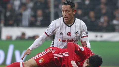 Besiktas' Adriano, top, tries to stop Benfica's Goncalo Guedes, during their Champions League Group B soccer match, in Istanbul, Wednesday, Nov. 23, 2016. (AP Photo)