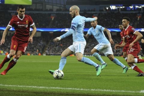 Manchester City's David Silva, center, competes for the ball with Liverpool's Dejan Lovren, left, during the Champions League quarterfinal second leg soccer match between Manchester City and Liverpool at Etihad stadium in Manchester, England, Tuesday, April 10, 2018. (AP Photo/Rui Vieira)