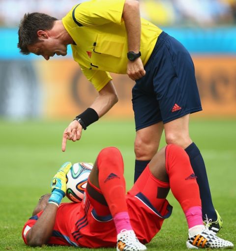 PORTO ALEGRE, BRAZIL - JUNE 25:  Referee Nicola Rizzoli gestures toward Vincent Enyeama of Nigeria as he lies on the field during the 2014 FIFA World Cup Brazil Group F match between Nigeria and Argentina at Estadio Beira-Rio on June 25, 2014 in Porto Alegre, Brazil.  (Photo by Paul Gilham/Getty Images)