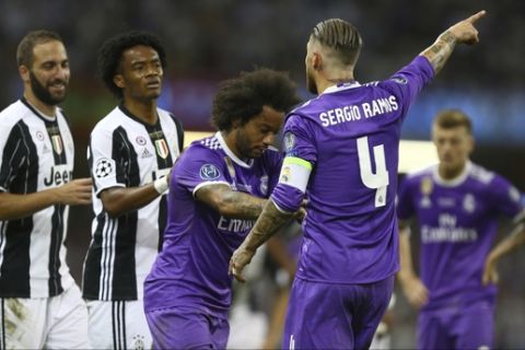 Real Madrid's Sergio Ramos gestures at Juventus' Juan Cuadrado, second left, to leave the field after he received a red card during the Champions League final soccer match between Juventus and Real Madrid at the Millennium stadium in Cardiff, Wales Saturday June 3, 2017. (AP Photo/Dave Thompson)